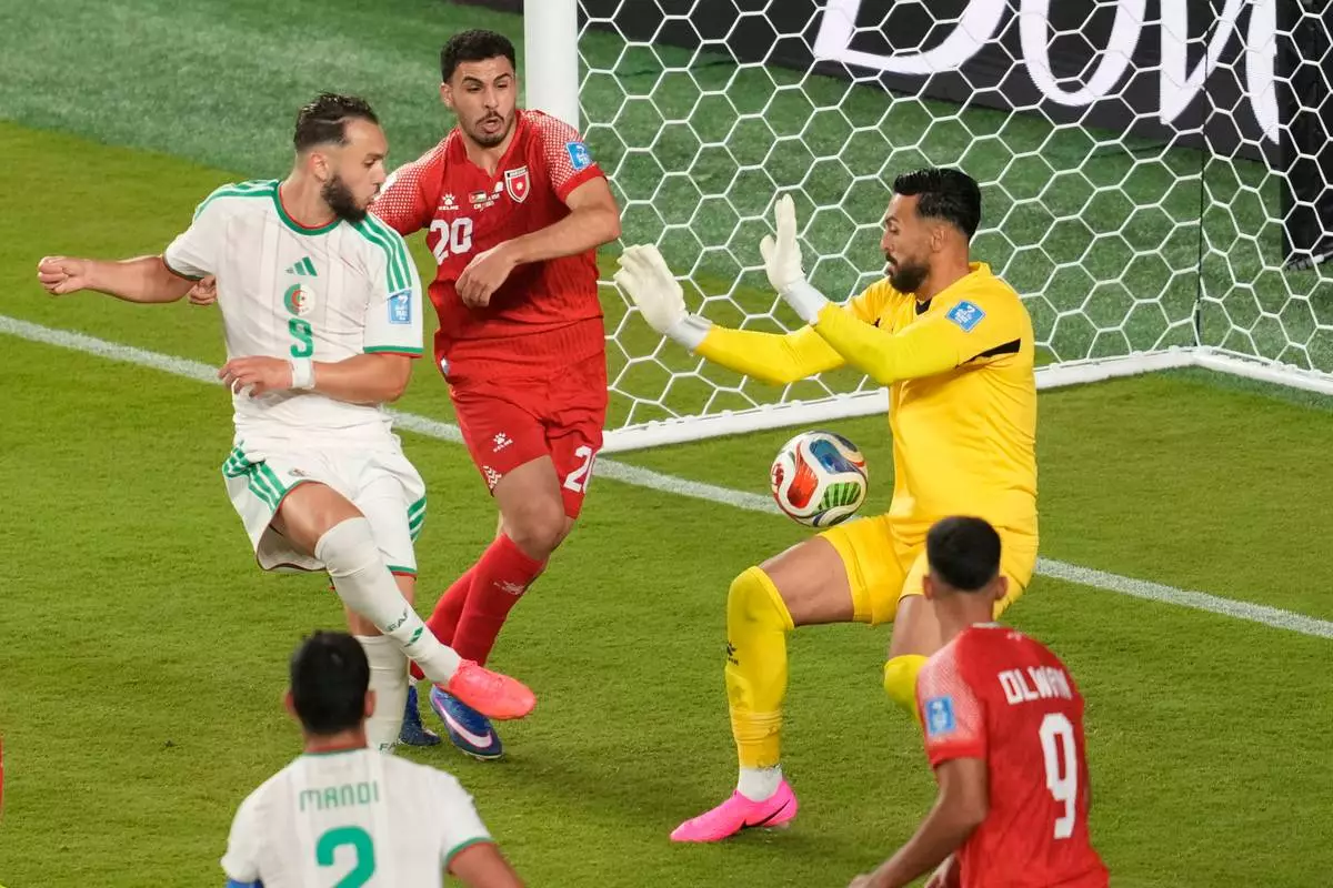 Algeria's Amine Gouiri (9) scores a goal past Jordan goalkeeper Yazeed Abulaila (1) during the World Cup Group J soccer match between Jordan and Algeria in Santa Clara, Calif., near San Francisco, Monday, June 22, 2026. (AP Photo/Jeff Chiu)