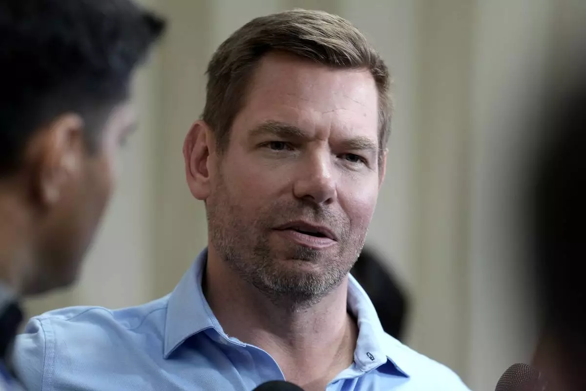 FILE - California gubernatorial candidate Rep. Eric Swalwell, D-Calif., talks with reporters after holding a town hall meeting in Sacramento, Calif., April 7, 2026. (AP Photo/Rich Pedroncelli, File)