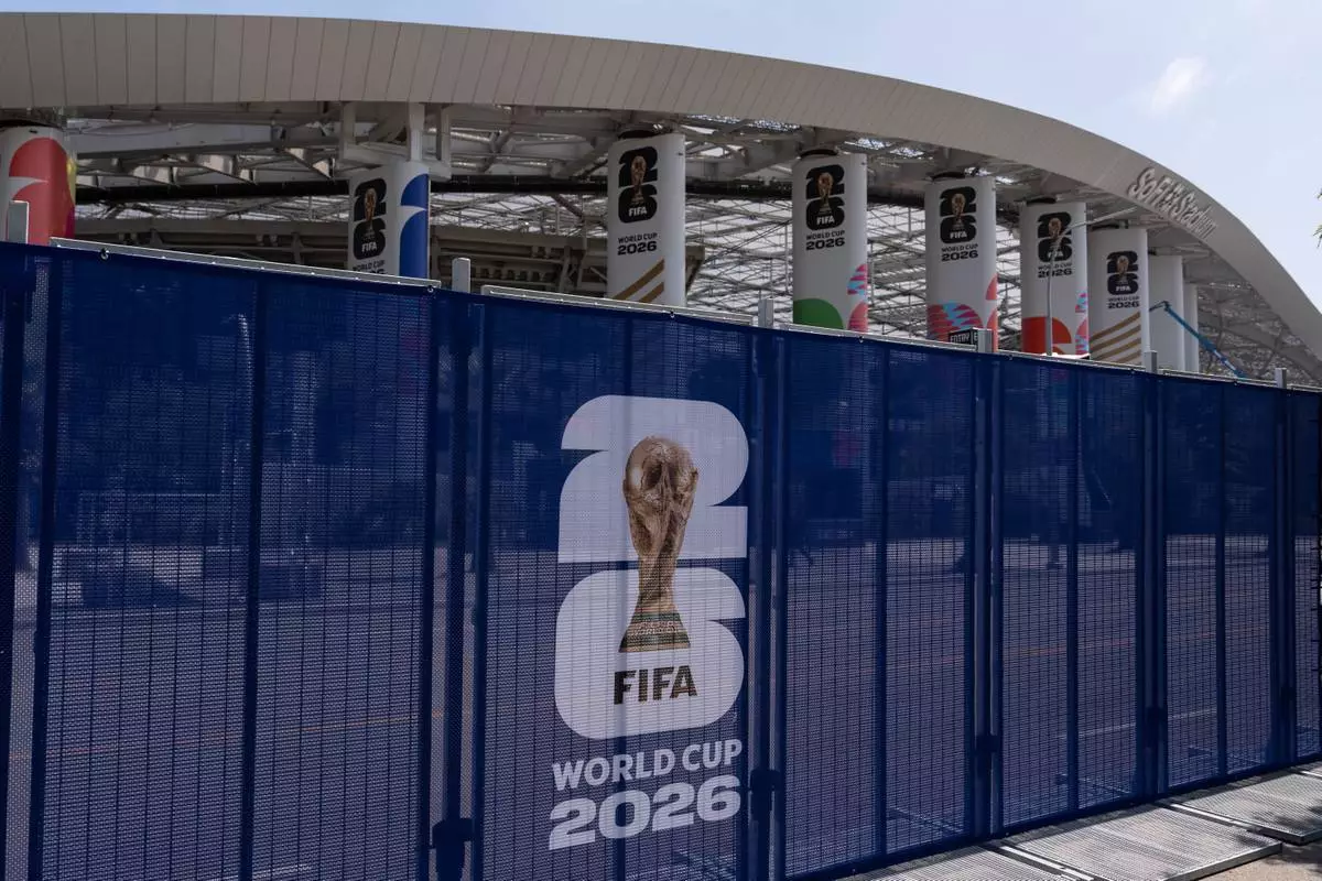 Temporary fencing with FIFA World Cup 2026 signage is set up outside SoFi Stadium, Friday, June 5, 2026, in Inglewood, Calif. (AP Photo/Jae C. Hong)