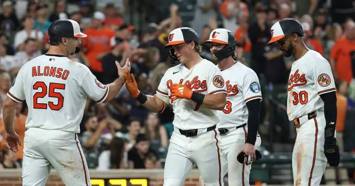 Holliday hits grand slam and Young pitches Orioles past Mariners 7-2 to stop 4-game slide
