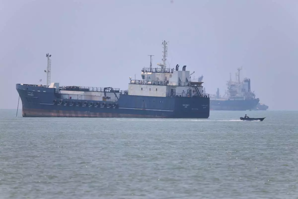 A small motorboat passes anchored vessels in the Strait of Hormuz off Bandar Abbas, Iran, Wednesday, June 17, 2026.(Amirhosein Khorgooi/ISNA via AP)