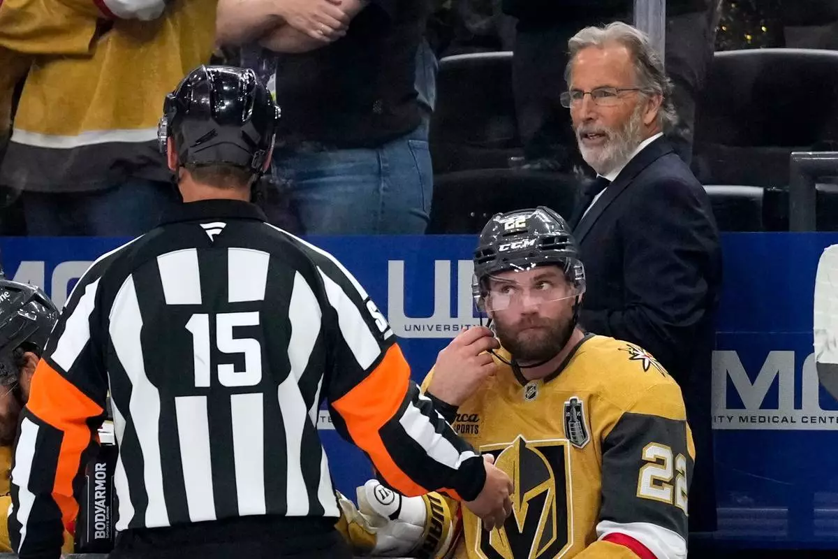 Vegas Golden Knights head coach John Tortorella, right, talks to a referee during the third period in Game 4 of the NHL hockey Stanley Cup Final series against the Carolina Hurricanes, Tuesday, June 9, 2026, in Las Vegas. (AP Photo/John Locher)