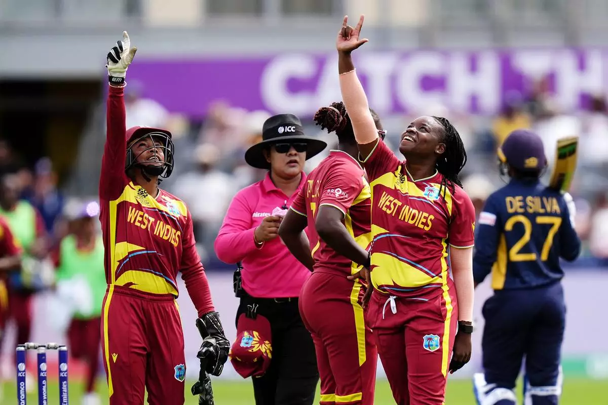 West Indies' Aaliyah Alleyne, right, celebrates taking the wicket of Sri Lanka's Kavisha Dilhari during the ICC Women's T20 World Cup match between Sri Lanka and West Indies, in Manchester, England, Sunday, June 21, 2026. ( Jacob King/PA via AP)