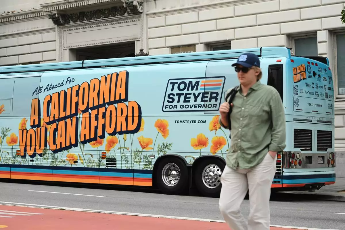 A bus is decorated outside of an election night event for California gubernatorial candidate Tom Steyer on Tuesday, June 2, 2026, in San Francisco. (AP Photo/Noah Berger)