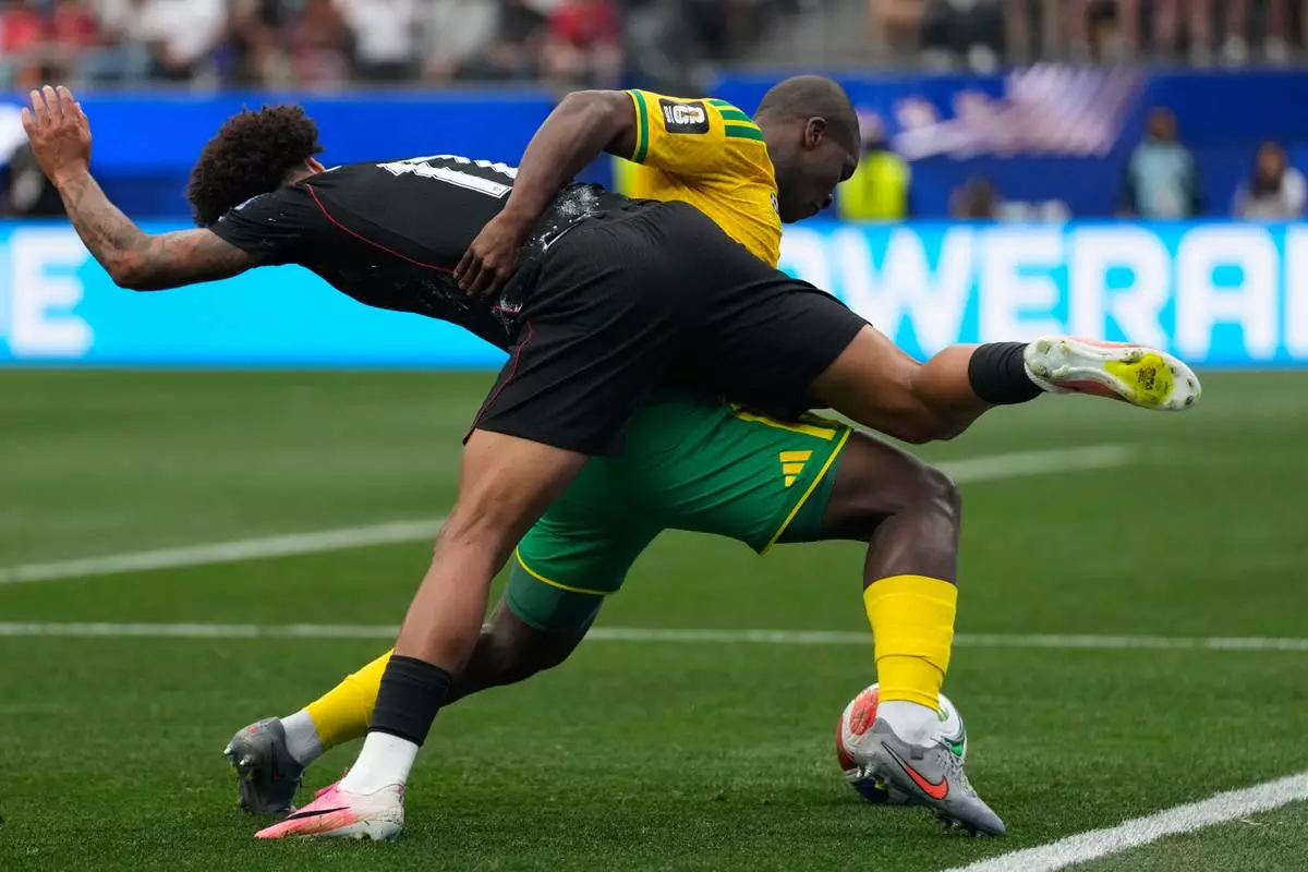 Canada's Tajon Buchanan, left, and South Africa's Mbekezeli Mbokazi battle for the ball during the World Cup round of 32 soccer match in Inglewood, Calif., near Los Angeles, Sunday, June 28, 2026. (AP Photo/Andre Penner)