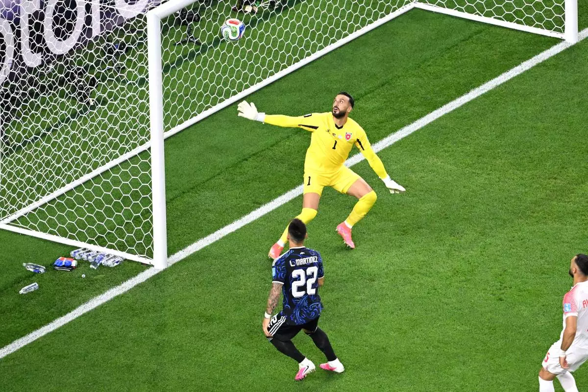 Argentina's Lautaro Martinez (22) and Jordan goalkeeper Yazeed Abulaila (1) watch the ball hit the crossbar during the World Cup Group J soccer match between Jordan and Argentina in Arlington, Texas, near Dallas, Saturday, June 27, 2026. (AP Photo/Jessica Tobias) CORRRECTION: Corrects to ball hitting crossbar, not a goal by Martinez.