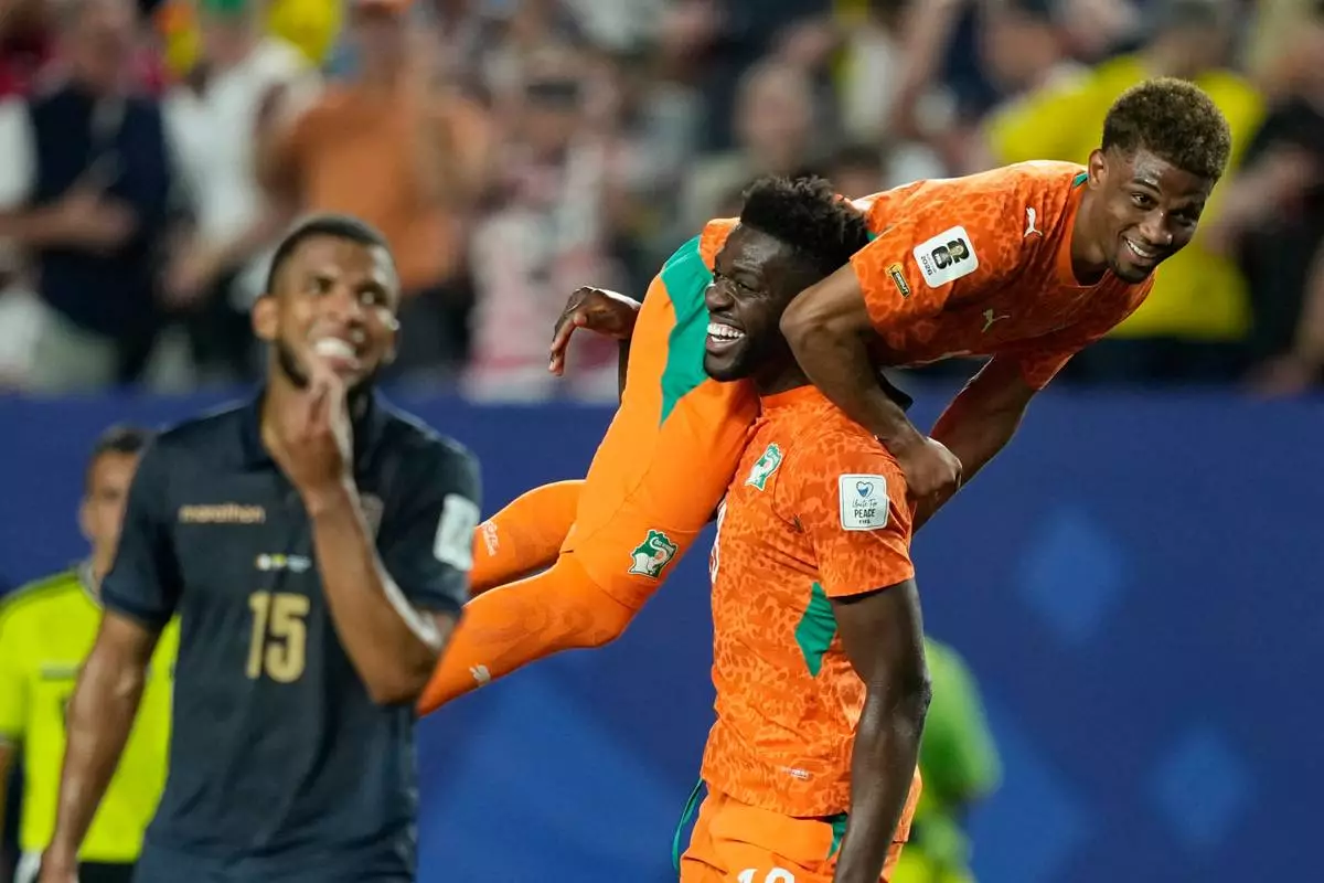 Ivory Coast's Ibrahim Sangare carries teammate Amad Diallo after defeating Ecuador in a World Cup Group E soccer match in Philadelphia, Sunday, June 14, 2026. (AP Photo/Matt Slocum)