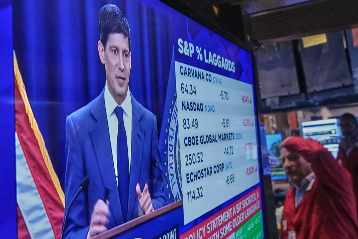 Federal Reserve Chair Kevin Warsh's press conference appears on a screen on the floor of the New York Stock Exchange, Wednesday, June 17, 2026. (AP Photo/Richard Drew)