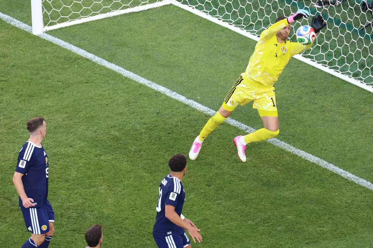 Scotland goalkeeper Angus Gunn (1) blocks a shot at goal during the World Cup Group C soccer match between Scotland and Morocco in Foxborough, Mass., near Boston, Friday, June 19, 2026. (AP Photo/Mark Stockwell)