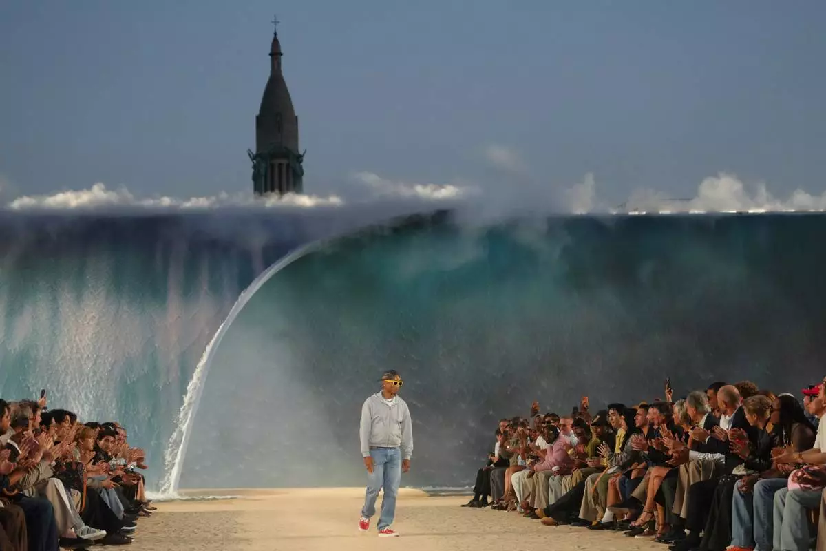 Designer Pharrell Williams accepts applause afte the Louis Vuitton men's Spring Summer 2027 collection presented in Paris, France, Tuesday, June 23, 2026. (AP Photo/Aurelien Morissard)