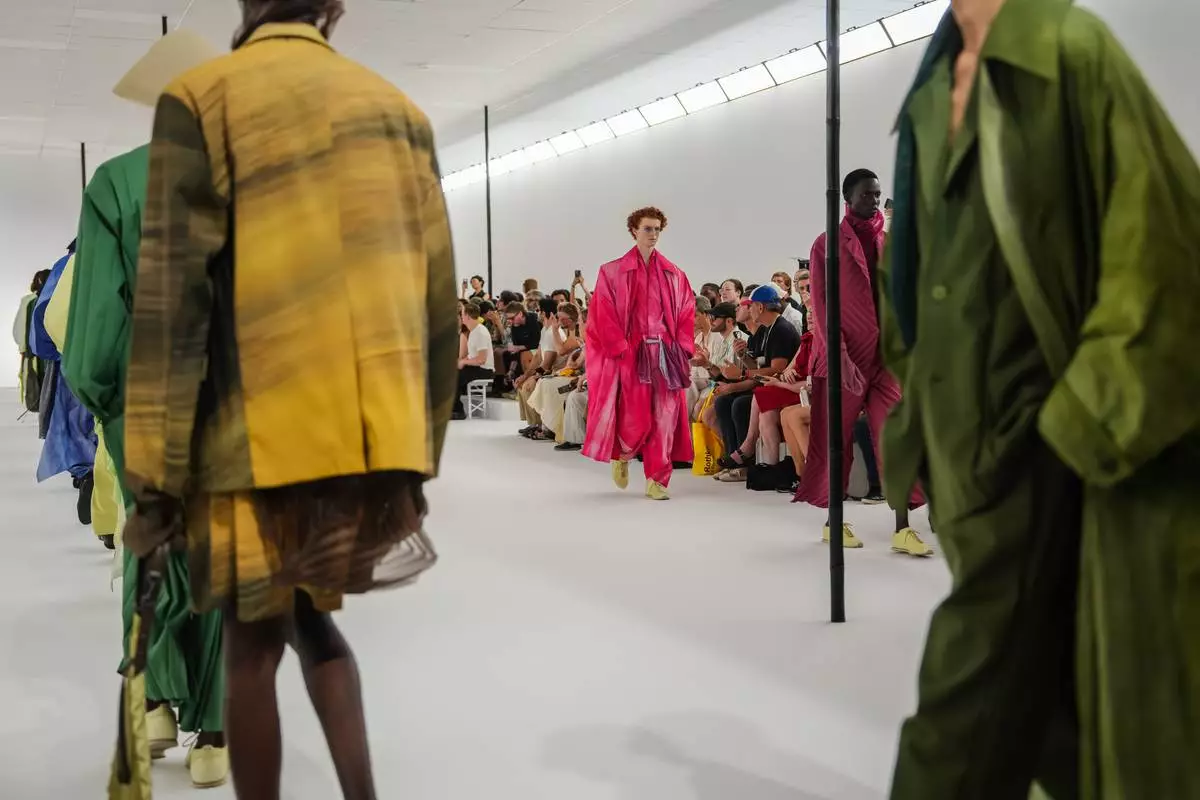 Models wear creations as part of the Issey Miyake Homme Spring Summer 2027 collection presented in Paris, France, Thursday, June 25, 2026. (AP Photo/Aurelien Morissard)