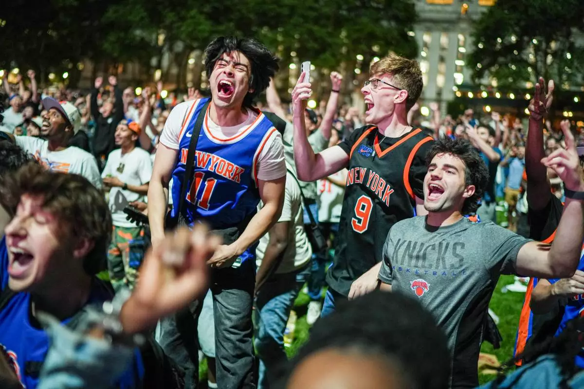 New York Knicks fans cheer at a watch party during Game 3 of the NBA Finals basketball series between the Knicks and the San Antonio Spurs, Monday, June 8, 2026, in New York. (AP Photo/Ryan Murphy)