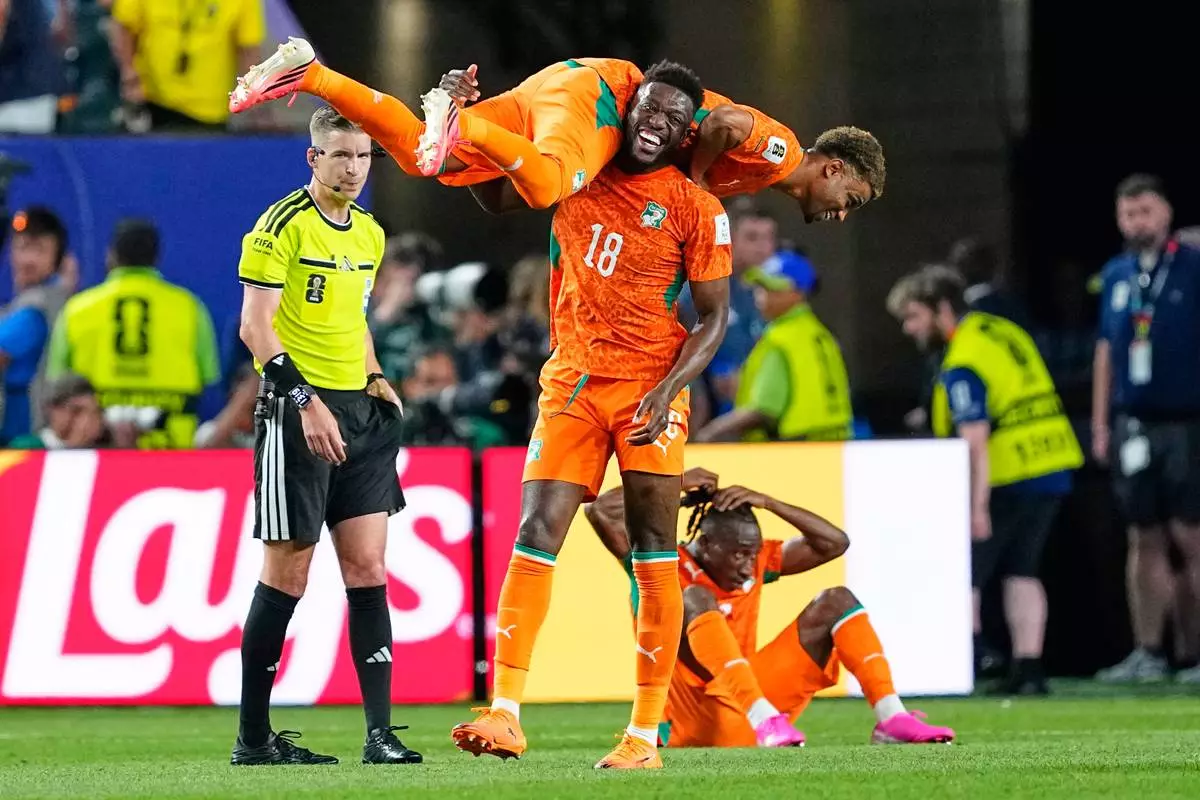 Ivory Coast's Ibrahim Sangare (18) carries teammate Amad Diallo (15) as they celebrate following their win in their World Cup Group E soccer match against Ecuador in Philadelphia, Sunday, June 14, 2026. (AP Photo/Petr David Josek)
