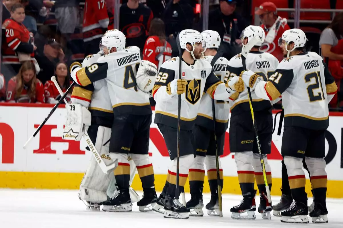Vegas Golden Knights congratulate goaltender Carter Hart following Game 1 of the NHL hockey Stanley Cup Final series against the Carolina Hurricanes in Raleigh, N.C., Tuesday, June 2, 2026. (AP Photo/Karl DeBlaker)