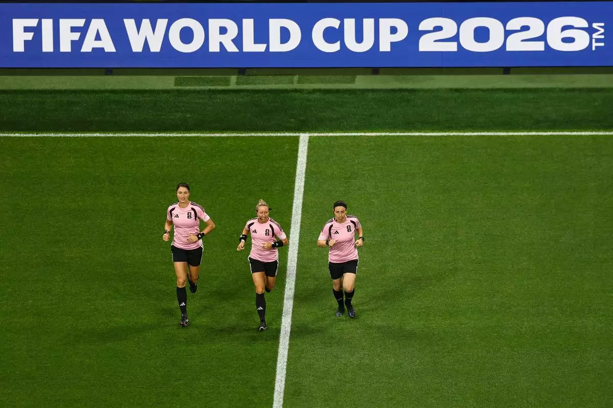 Referee Tori Penso jogs flanked by assistant referees Kathryn Nesbitt, left, and Brooke Mayo during warmup before the World Cup Group A soccer match between Czechia and South Africa in Atlanta, Thursday, June 18, 2026. (AP Photo/Colin Hubbard)