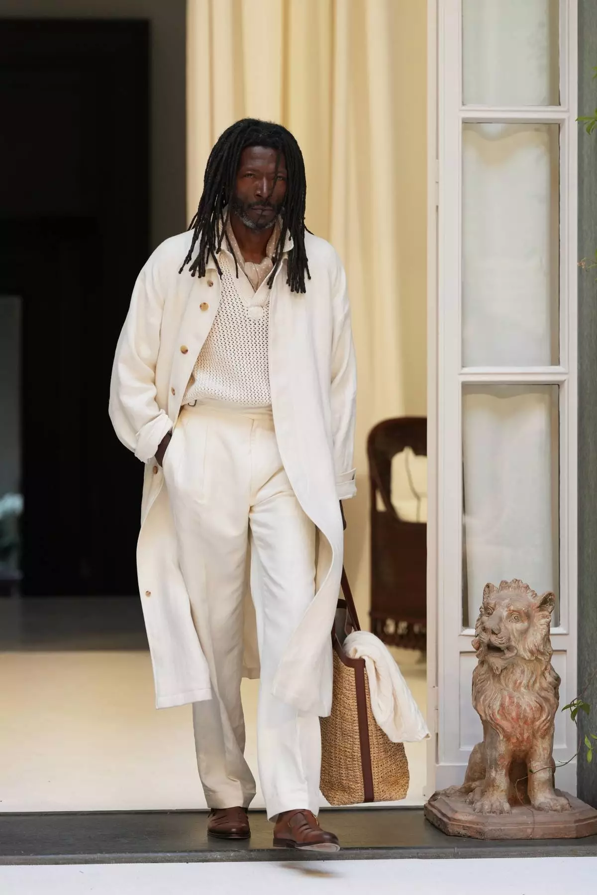 A model wears a creation as part of the Ralph Lauren Spring/Summer 2027 men's collection presented in Milan, Italy, Friday, June 19, 2026. (AP Photo/Antonio Calanni)