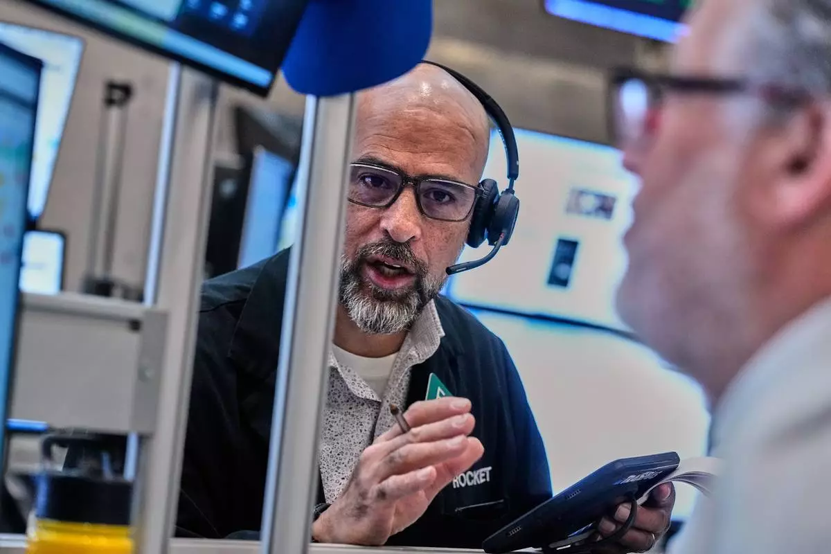 Options traders Steven Rodriguez, left, and Marty Handler work on the floor of the New York Stock Exchange, Wednesday, June 3, 2026. (AP Photo/Richard Drew)