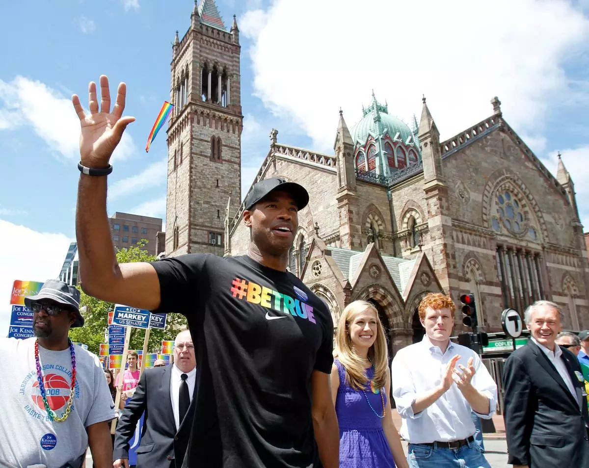 FILE - This June 8, 2013 file photo shows NBA veteran Jason Collins, left, marching in Boston's gay pride parade alongside U.S. Rep. Joe Kennedy III, a college roommate, second right, and Kennedy's wife Lauren Anne Birchfield, center, in Boston. (AP Photo/Mary Schwalm, file)