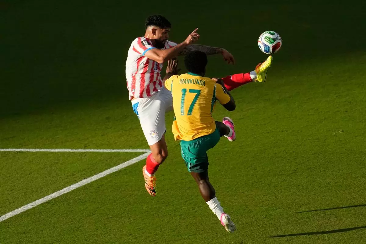 Paraguay's Omar Alderete (3) kicks the ball over Australia's Nestory Irankunda (17) during the World Cup Group D soccer match between Paraguay and Australia in Santa Clara, Calif., near San Francisco, Thursday, June 25, 2026. (AP Photo/Jeff Chiu)
