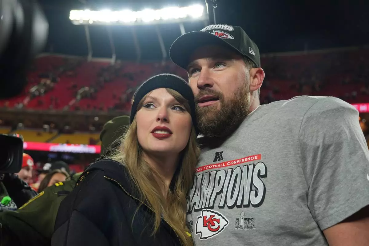 FILE - Kansas City Chiefs tight end Travis Kelce, right, is congratulated by Taylor Swift as they celebrate the Chiefs' victory over the Buffalo Bills in the AFC Championship NFL football game, Jan. 26, 2025, in Kansas City, Mo. (AP Photo/Charlie Riedel, File)