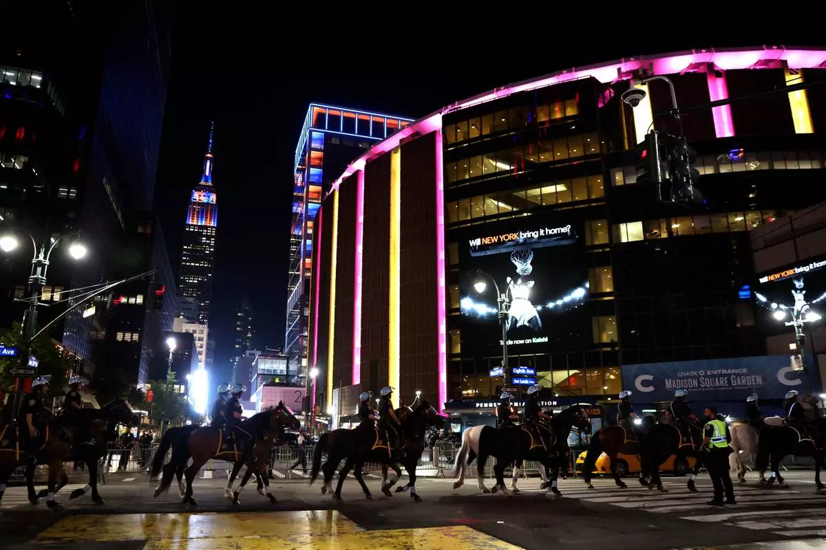 FILE - New York City police on horseback patrol the street by Madison Square Garden during Game 5 of the NBA Finals basketball series against the San Antonio Spurs, June 13, 2026, in New York. (AP Photo/Heather Khalifa, File)