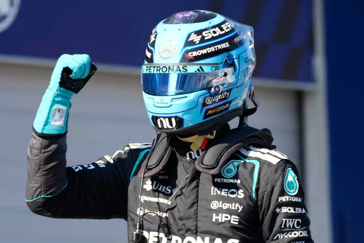 Mercedes driver George Russell of Britain celebrates after setting the pole position during the qualifying session ahead of the Austrian F1 Grand Prix, in Spielberg, Austria, Saturday, June 27, 2026. (AP Photo/Darko Bandic)