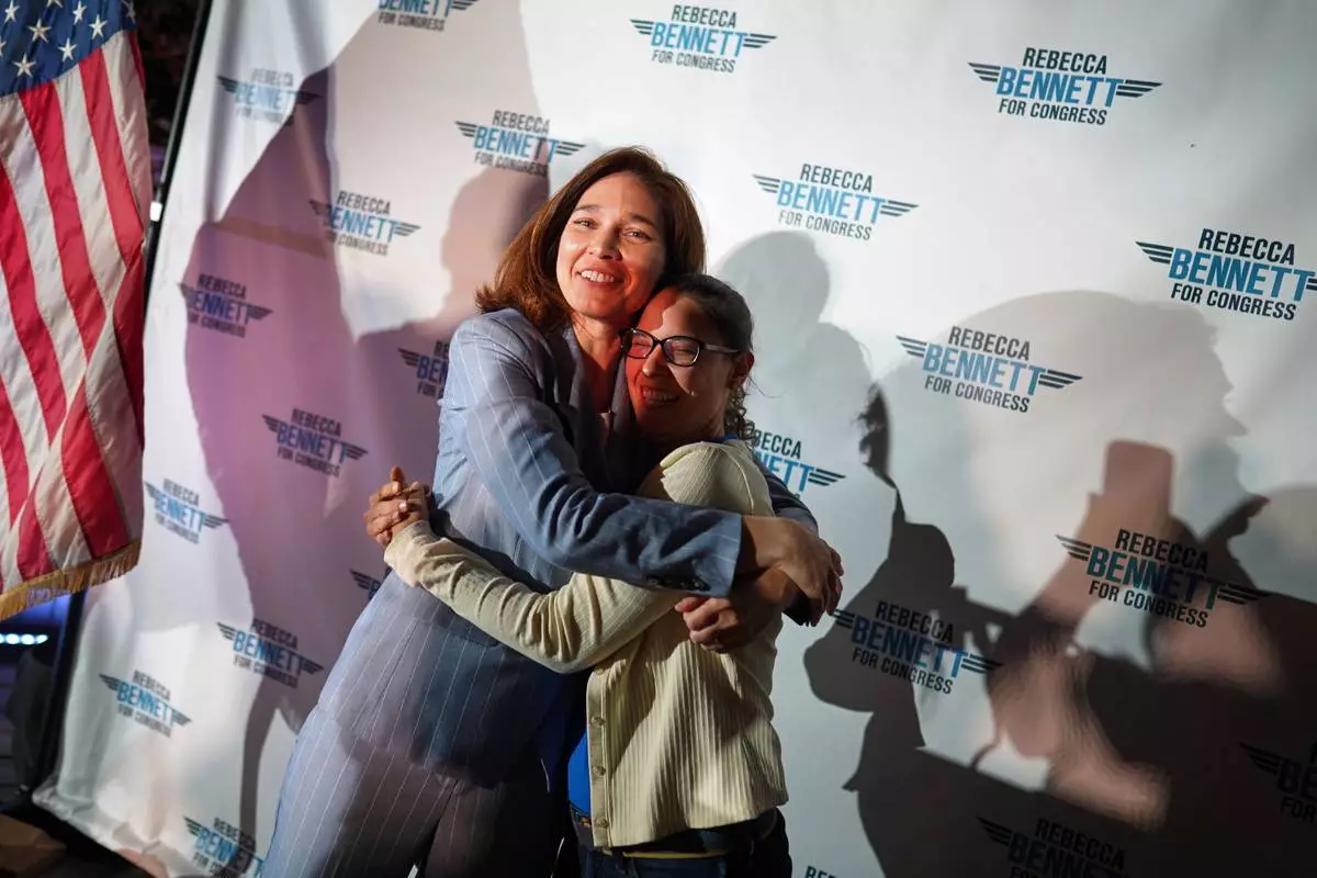 Rebecca Bennett, Democratic candidate for New Jersey's 7th Congressional District, hugs an attendee during a primary election night watch party after winning the Democratic nomination Tuesday, June 2, 2026, in Bridgewater, N.J. (AP Photo/Ryan Murphy)