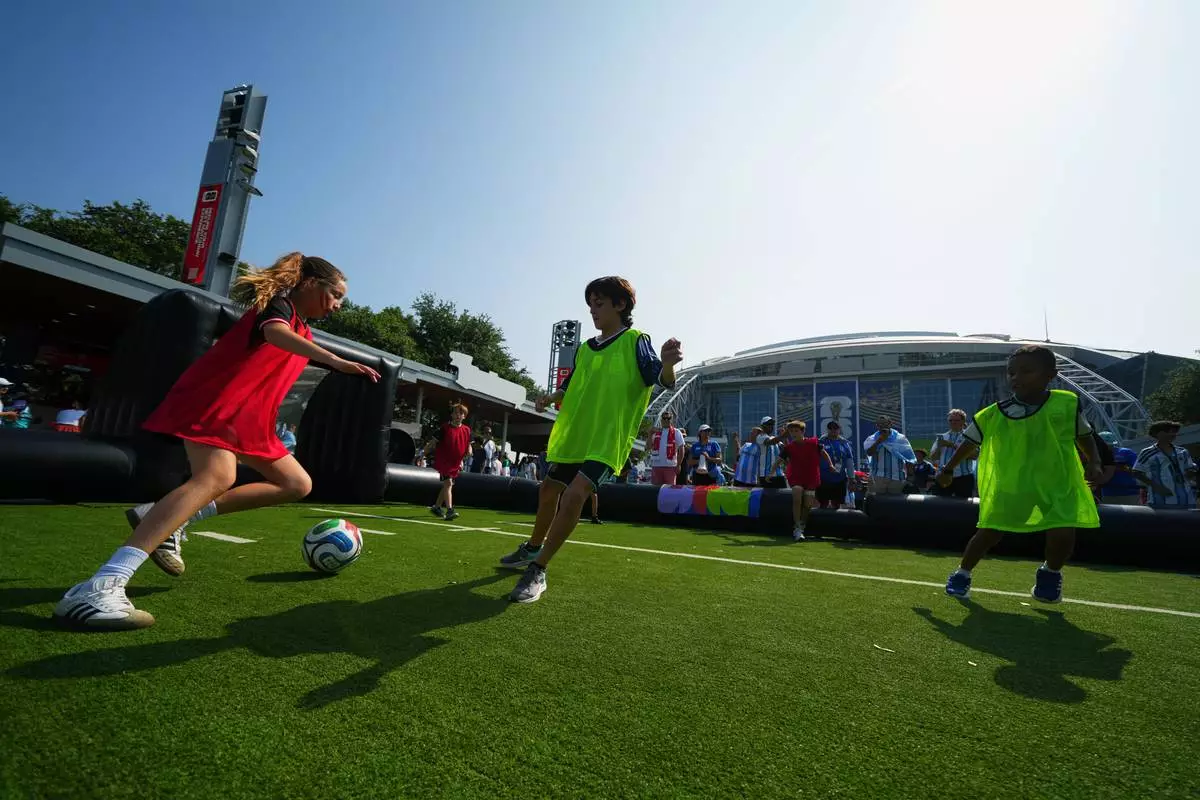 FILE - Children wearing shirts of Austria and Argentina play soccer outside the stadium before the World Cup Group J soccer match between Argentina and Austria in Arlington, Texas, near Dallas, Monday, June 22, 2026. (AP Photo/Julio Cortez,File)