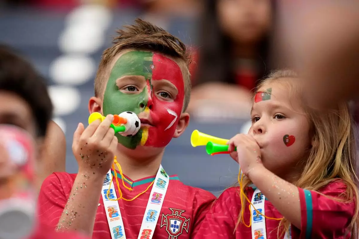 FILE - Children wait for the start of the World Cup Group K soccer match between Portugal and Uzbekistan in Houston, Tuesday, June 23, 2026. (AP Photo/Eric Gay,File)