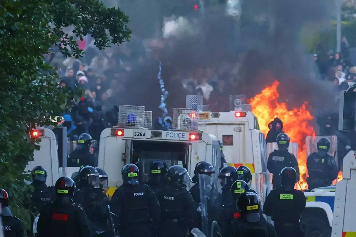 Police attempt to disperse protesters near Newtownabbey, in Belfast, Northern Ireland, Wednesday, June 10, 2026, following a stabbing incident on Monday night. (AP Photo/Peter Morrison)