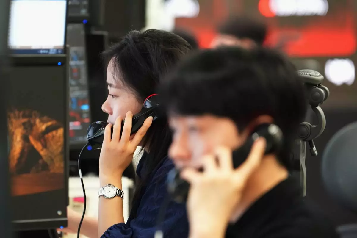 Dealers talk on the phones at a dealing room of Hana Bank in Seoul, South Korea, Thursday, June 11, 2026. (AP Photo/Lee Jin-man)