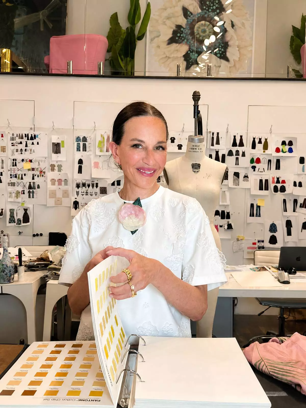 Fashion designer Cynthia Rowley in her design studio, wearing the limited-edition brooch she created for the launch of Downy Boutique Botanicals.