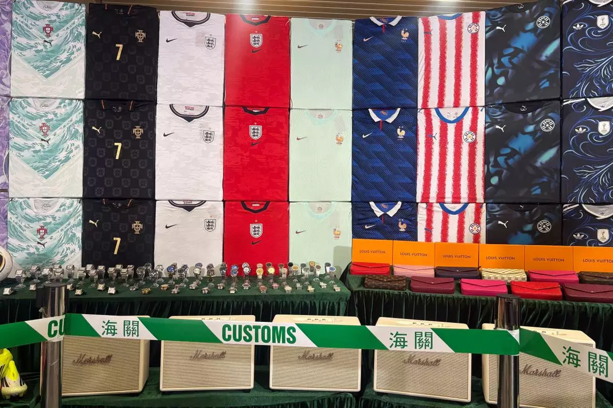 Hong Kong customs authorities showcase various types of fake goods they seized during a news conference at its headquarters in North Point, Hong Kong Thursday, June 11, 2026. (AP Photo/Kanis Leung)