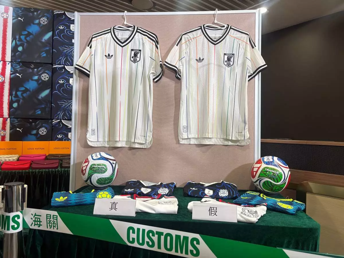 Hong Kong customs authorities showcase real jersey, left, and fake jersey, right, during a news conference at its headquarters in North Point, Hong Kong Thursday, June 11, 2026. (AP Photo/Kanis Leung)