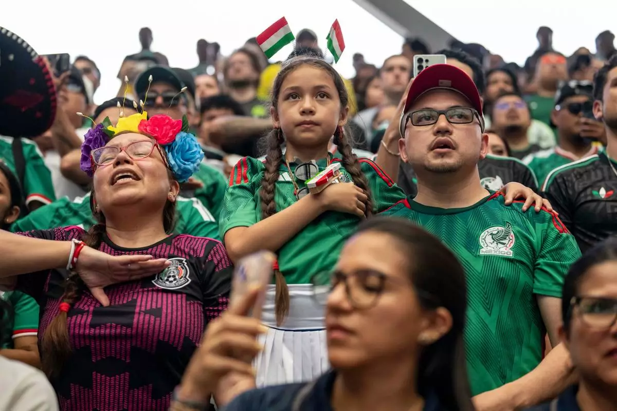 Supporters of Mexico sing the national anthem before the opening match of the World Cup soccer tournament between Mexico and South Africa, Thursday, June 11, 2026, at the USTA Billie Jean King National Tennis Center in New York. (AP Photo/Yuki Iwamura)