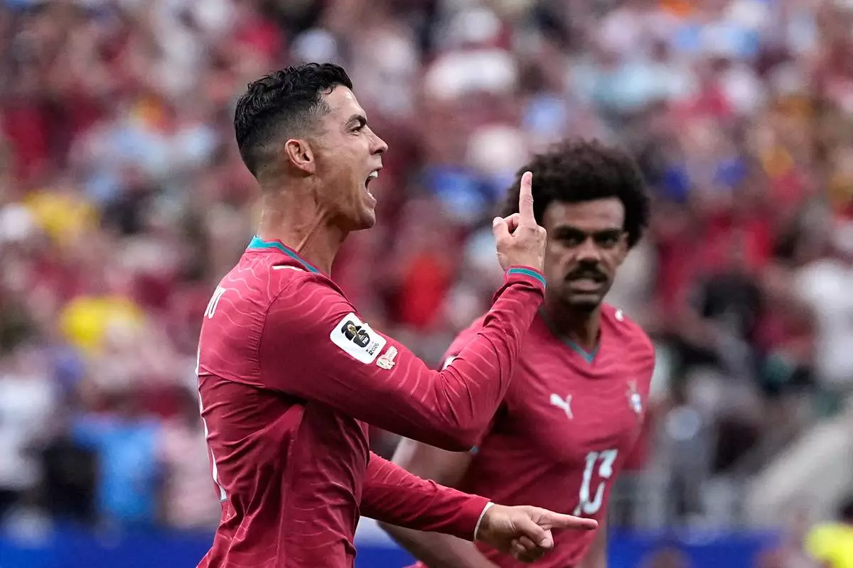 Portugal's Cristiano Ronaldo celebrates after scoring the opening goal during the World Cup Group K soccer match between Portugal and Uzbekistan in Houston, Tuesday, June 23, 2026. (AP Photo/Ashley Landis)