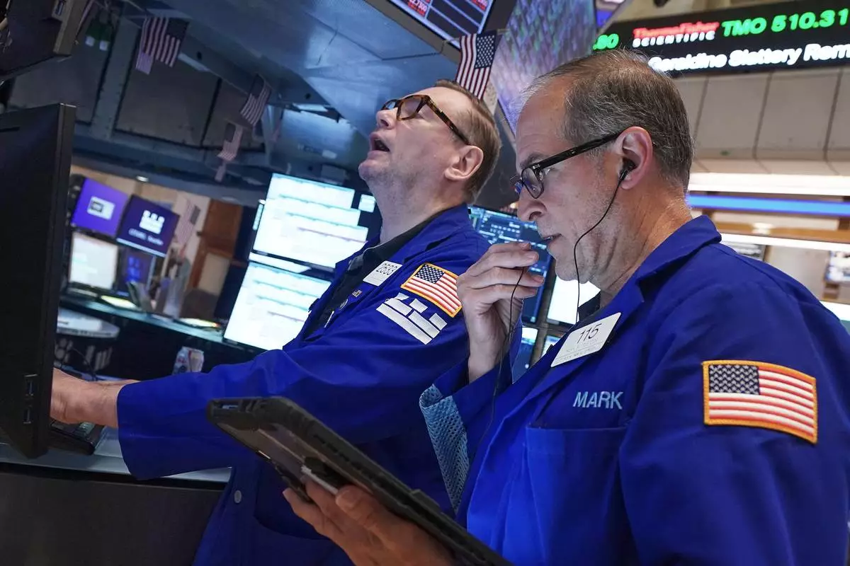 Specialist Patrick King, left, and trader Mark Puetzer work on the floor of the New York Stock Exchange, Friday, June 26, 2026. (AP Photo/Richard Drew)