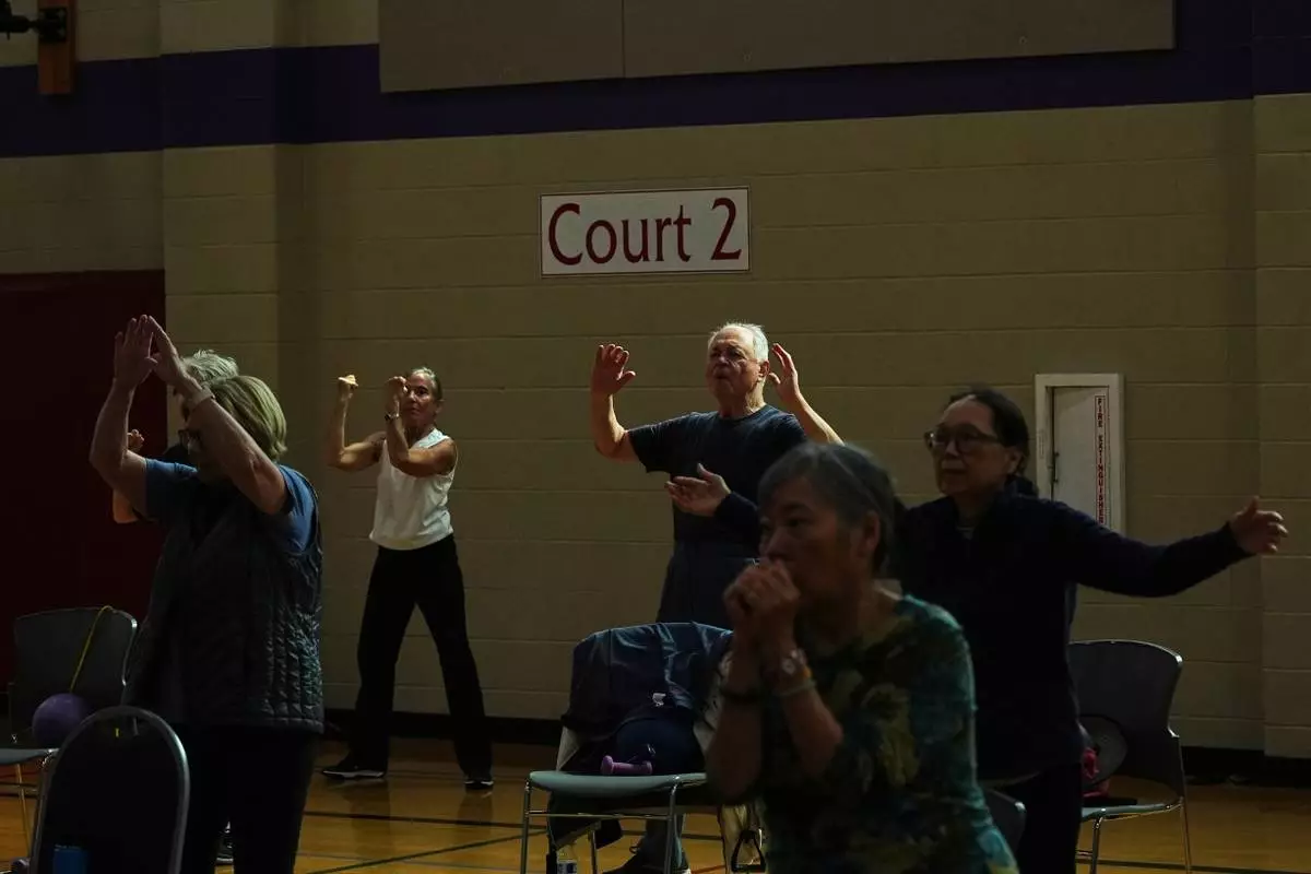 Participants do arm exercises in a class for older adults led by instructor Bengie Santos, 72, at the Dale Turner Family YMCA, April 30, 2026, in Shoreline, Wash. (AP Photo/Lindsey Wasson)