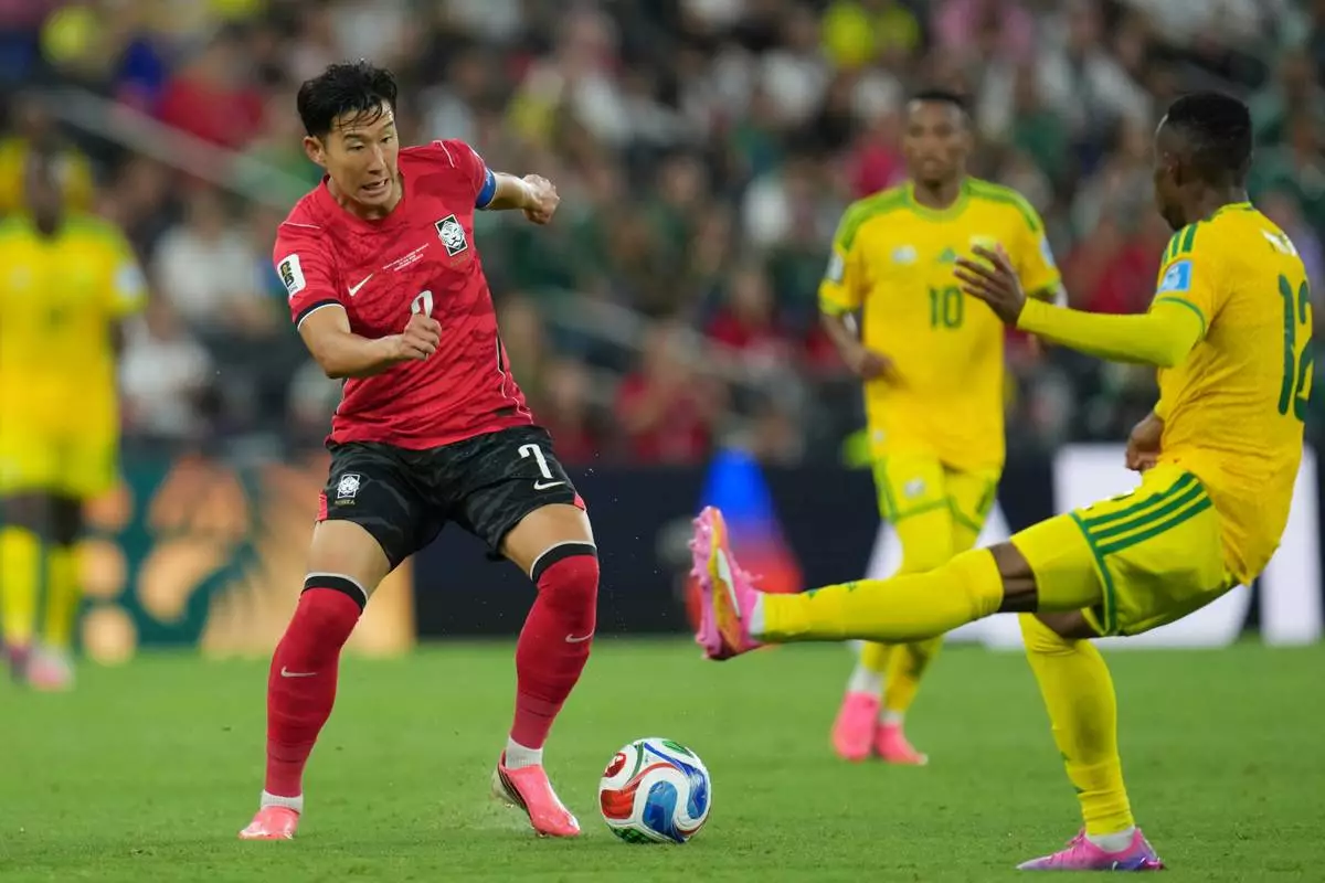 South Korea's Son Heung-min (7) controls the ball against South Africa's Thapelo Maseko (12) during the World Cup Group A soccer match between South Africa and South Korea in Guadalupe, near Monterrey, Mexico, Wednesday, June 24, 2026. (AP Photo/Matias Delacroix)