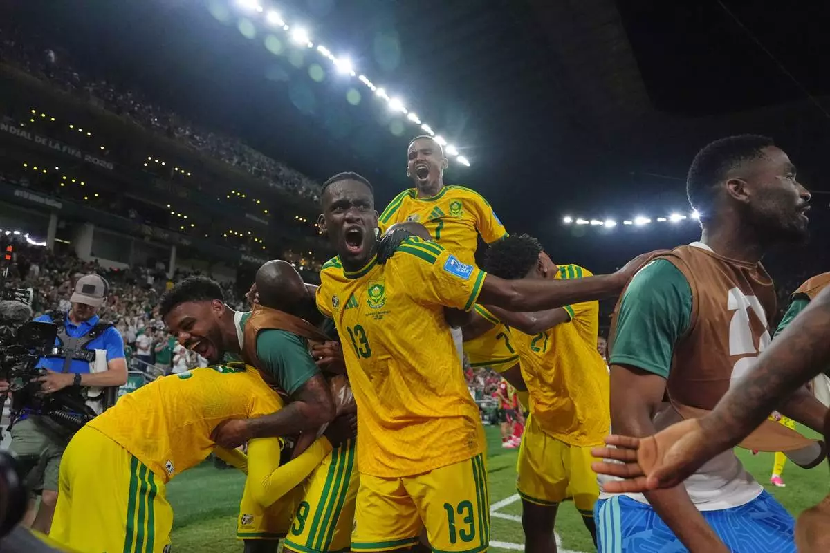 South Africa's Thapelo Maseko (12) celebrates with teammates after scoring his side's first goal during the World Cup Group A soccer match between South Africa and South Korea in Guadalupe, near Monterrey, Mexico, Wednesday, June 24, 2026. (AP Photo/Moises Castillo)