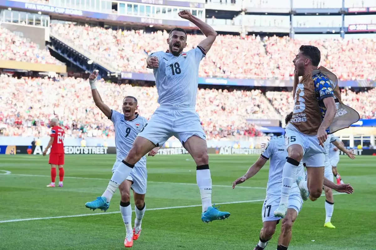 Iraq's Aymen Hussein (18), celebrates scoring his side's first goal during the World Cup Group I soccer match between Iraq and Norway in Foxborough, Mass., near Boston, Tuesday, June 16, 2026. (AP Photo/Martin Meissner)