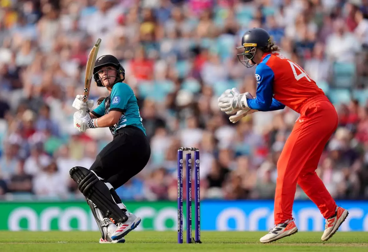 New Zealand's Melie Kerr, left, batting as England wicket keeper Amy Jones looks on during the Women's T20 World Cup cricket match between England and New Zealand at The Kia Oval in London, Saturday June 27, 2026. (Ben Whitley/PA via AP)