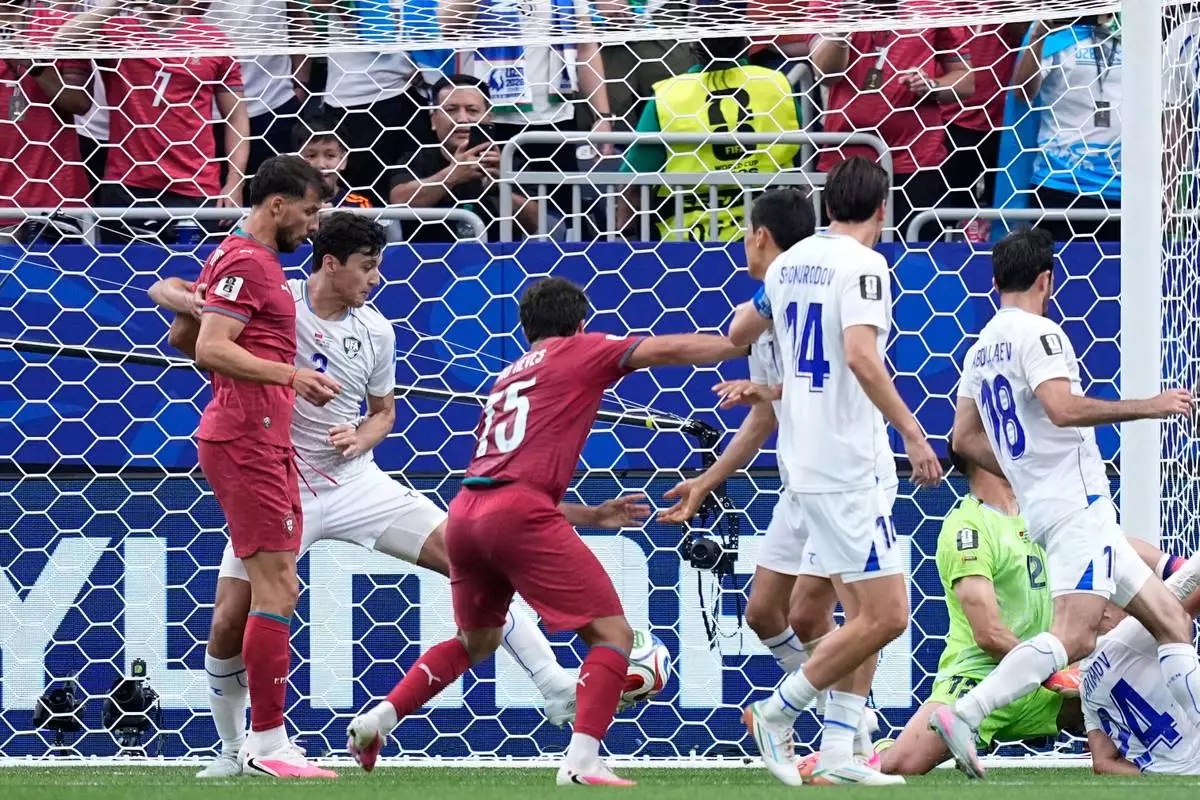 Uzbekistan's Abduvohid Nematov (12) scores an own goal during the World Cup Group K soccer match between Portugal and Uzbekistan in Houston, Tuesday, June 23, 2026. (AP Photo/Ashley Landis) CORRECTION - Corrects player who scored an own goal to Abduvohid Nematov (12)