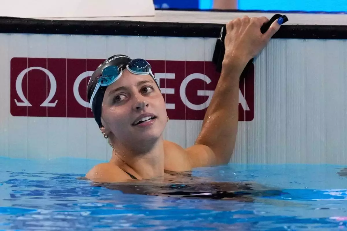 FILE -Kate Douglass of the United States reacts after winning gold medal in the women's 200-meter breaststroke final at the World Aquatics Championships in Singapore, Friday, Aug.1, 2025. (AP Photo/Vincent Thian, File)