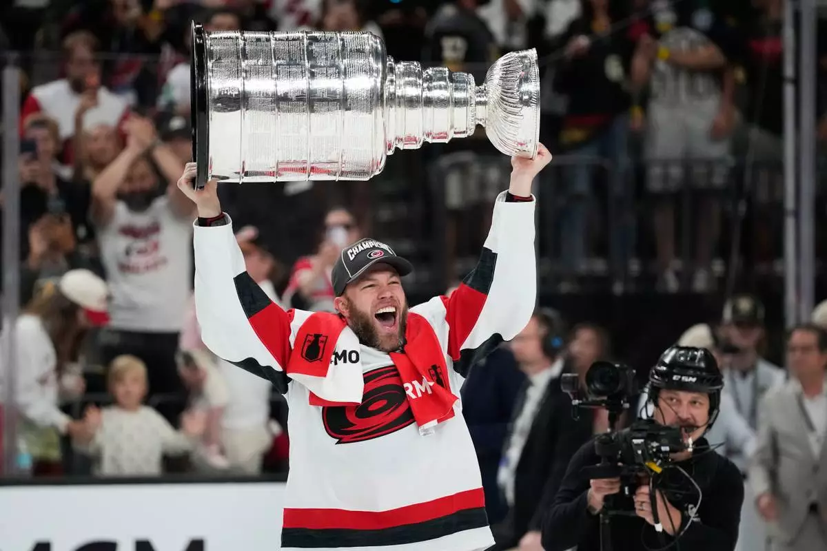Carolina Hurricanes left wing Taylor Hall celebrates after a win over the Vegas Golden Knights in Game 6 of the NHL hockey Stanley Cup Final series, Sunday, June 14, 2026, in Las Vegas. (AP Photo/John Locher)