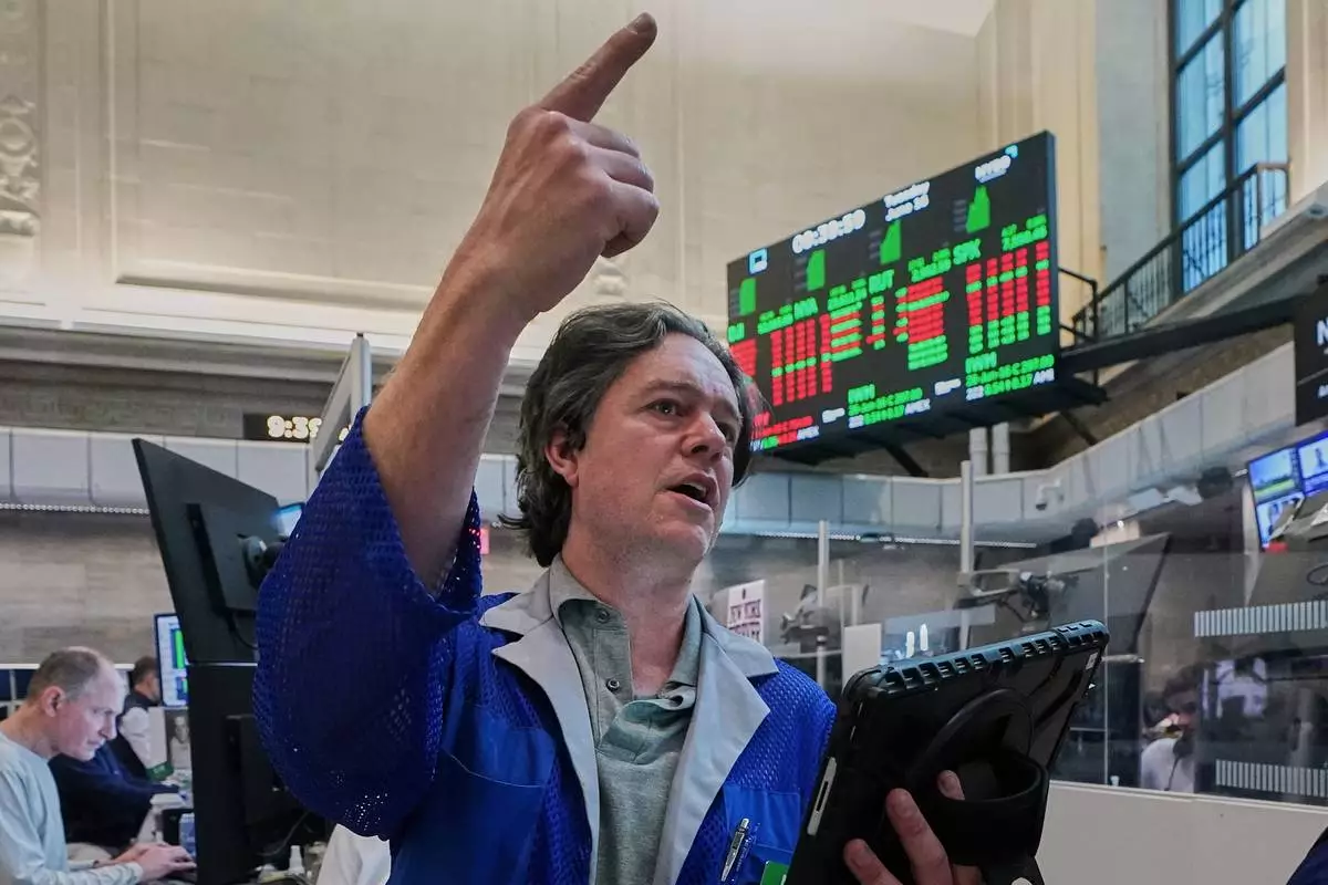 Options trader Doran Swan works on the floor of the New York Stock Exchange, Tuesday, June 16, 2026. (AP Photo/Richard Drew)