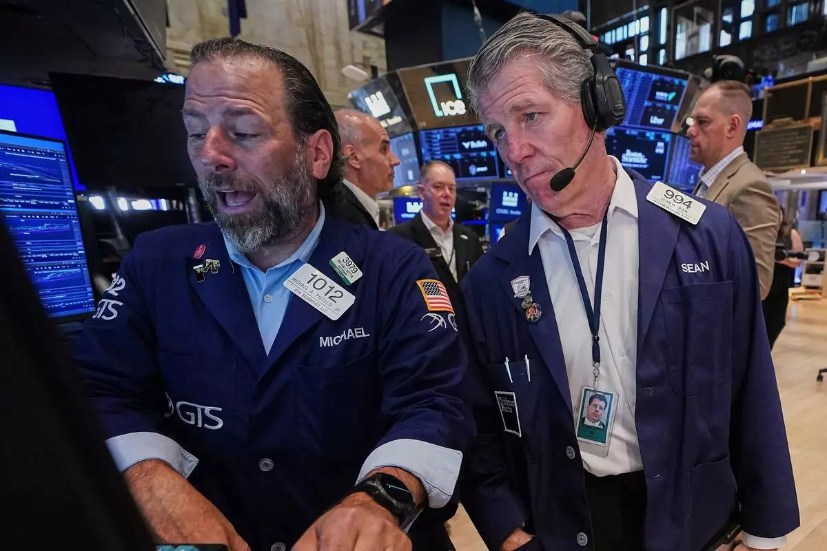 Specialist Michael Pistillo, left, and trader Sean Spain work on the floor of the New York Stock Exchange, Tuesday, June 16, 2026. (AP Photo/Richard Drew)