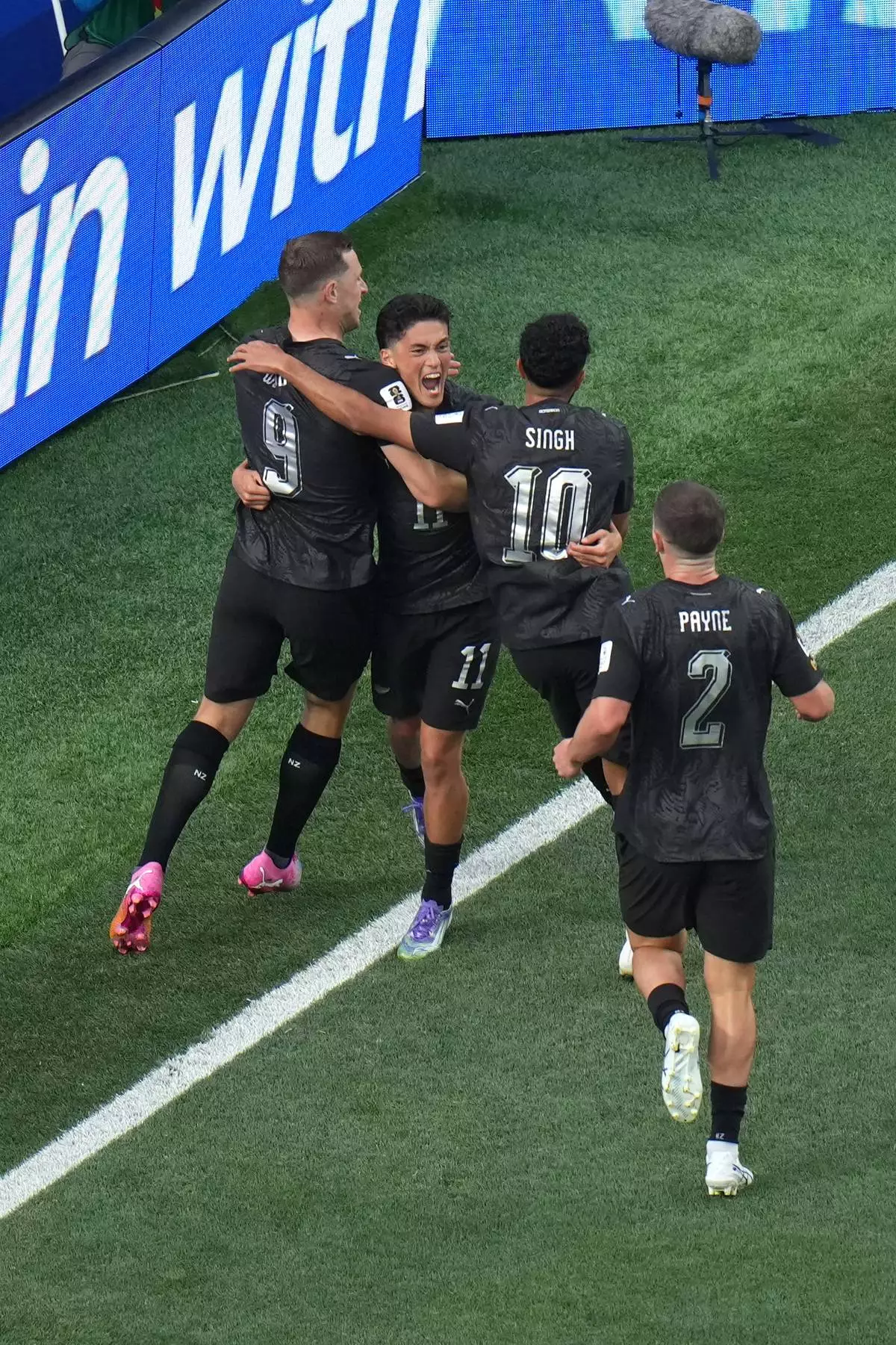 New Zealand's Elijah Just, center, celebrates with Chris Wood (9) and Sarpreet Singh (10) and Tim Payne (2) after scoring their opening goal during the World Cup Group G soccer match between Iran and New Zealand in Inglewood, Calif., near Los Angeles, Monday, June 15, 2026. (AP Photo/Jae C. Hong)