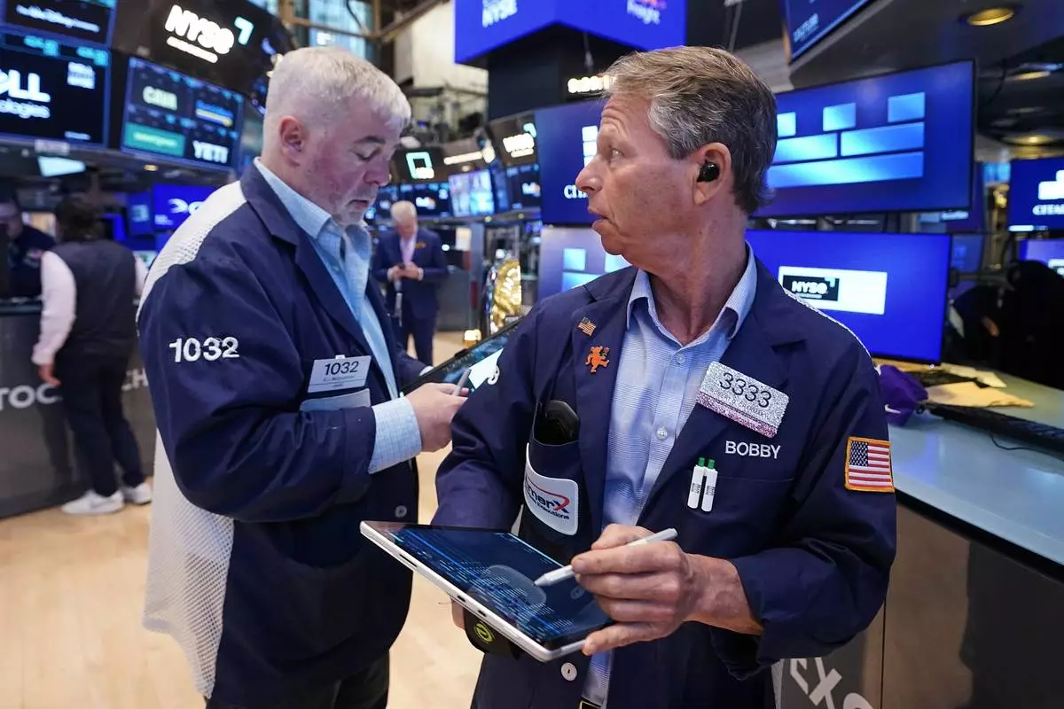 Traders Edward McCarthy, left, and Robert Charmak work on the floor of the New York Stock Exchange, Monday, June 1, 2026. (AP Photo/Richard Drew)