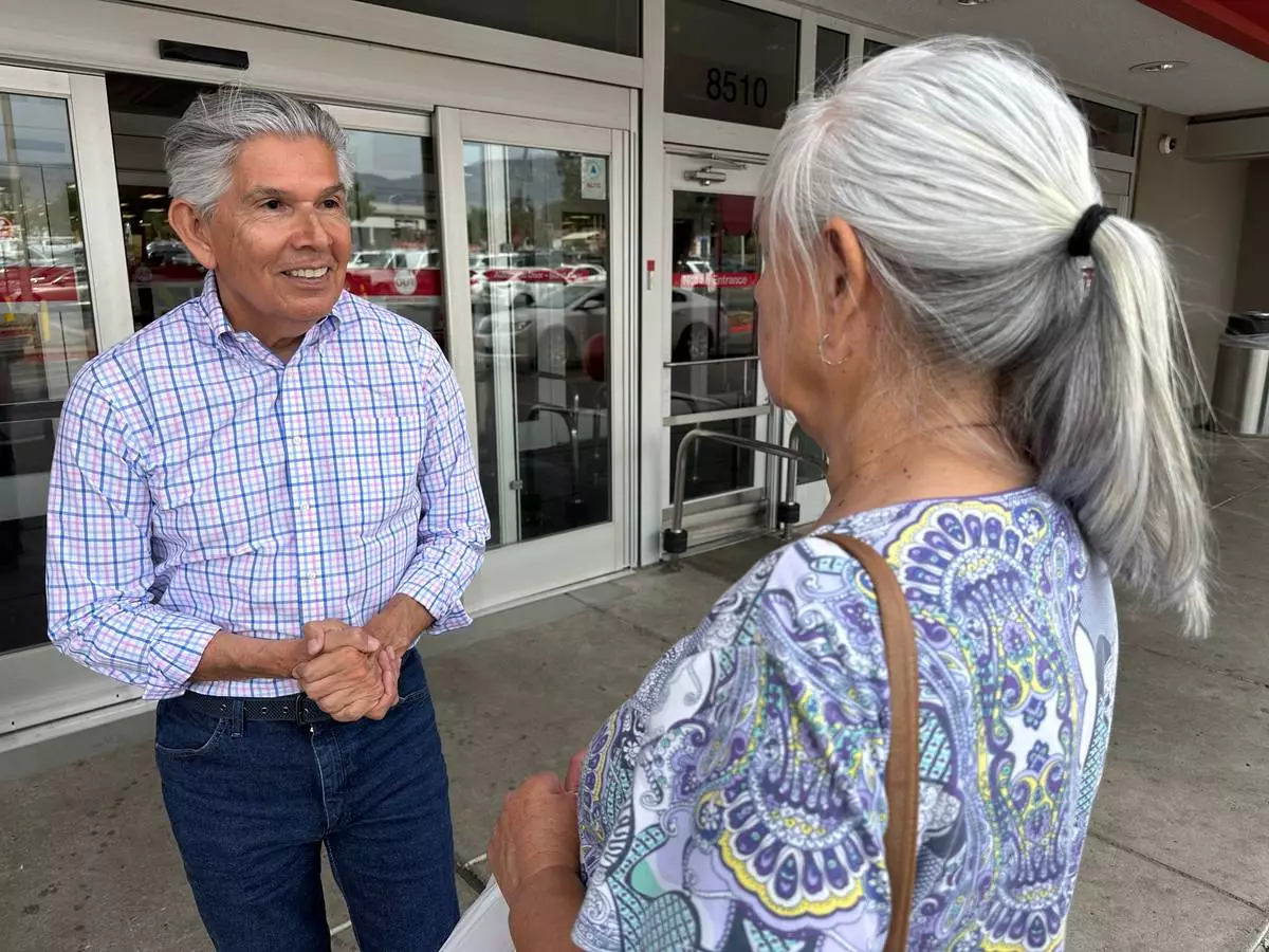 Republican gubernatorial candidate Duke Rodriguez talks with a voter in Albuquerque, N.M., Tuesday, June 2, 2026. (AP Photo/Susan Montoya Bryan)